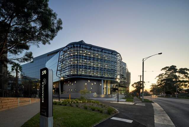 Photograph of Botanicca 3 Building lit up at twilight